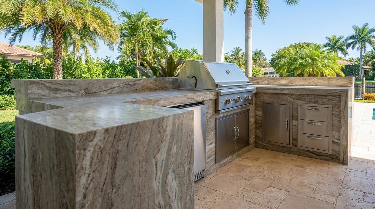 Finished outdoor kitchen with granite counters, grill, and palm trees